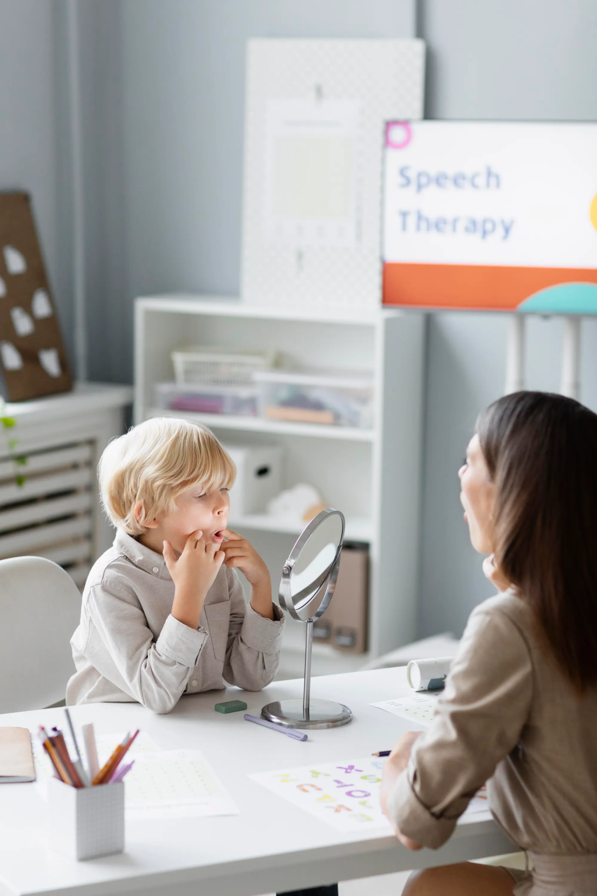 Boy practices speech with therapist