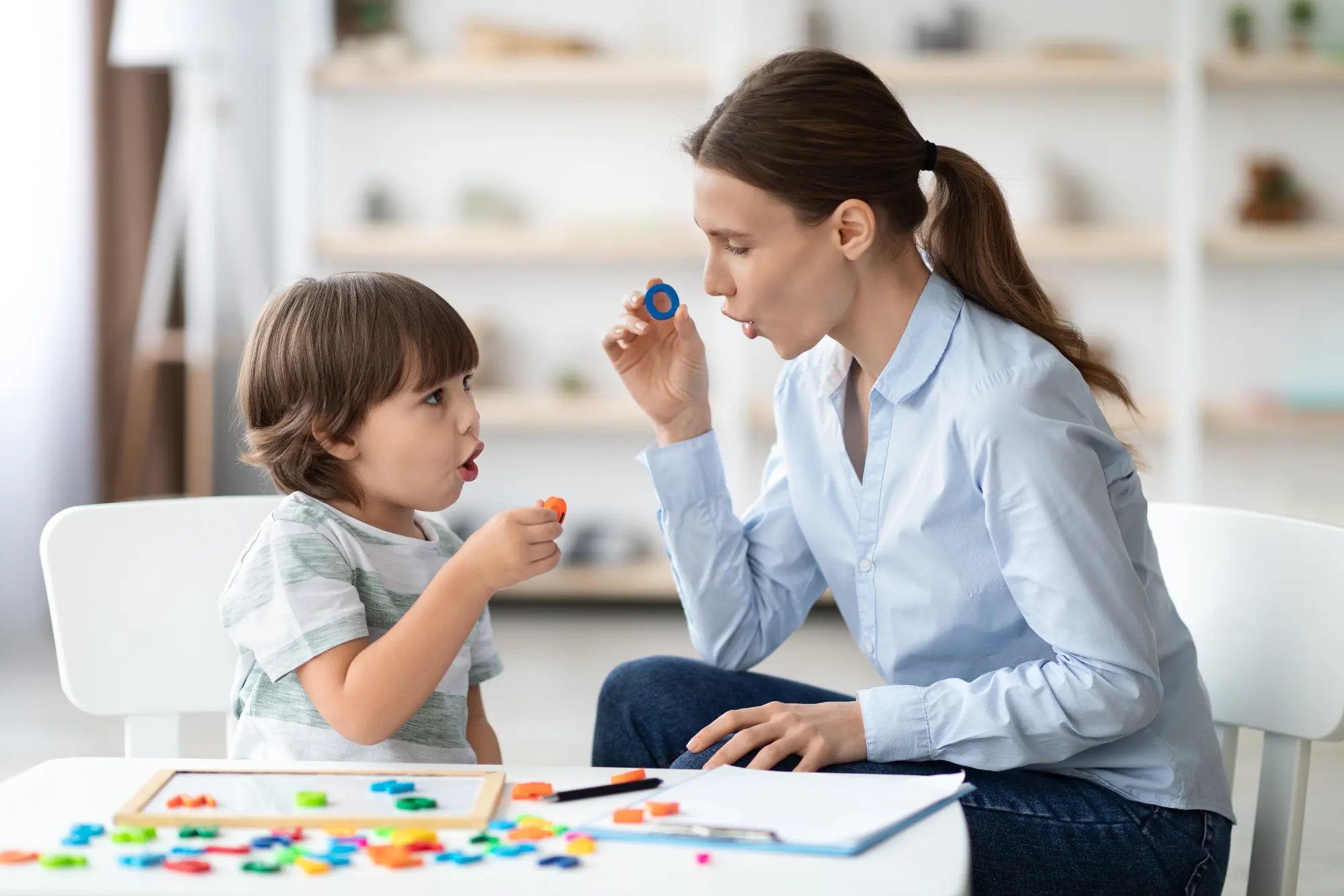 Speech therapist plays educational game with young patient